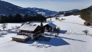 an aerial view of a house in the snow at Pircherhof Appartements in Haus im Ennstal