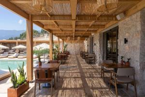 a restaurant with tables and chairs next to a pool at Radisson Blu Hotel, Kas in Kaş