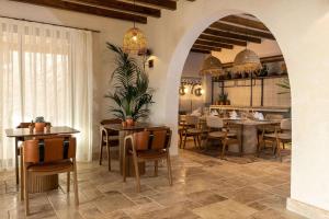 a dining room with tables and chairs and a kitchen at Radisson Blu Hotel, Kas in Kaş