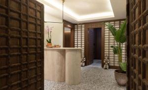 a hallway with a counter in a room with plants at Radisson Blu Hotel, Kas in Kaş