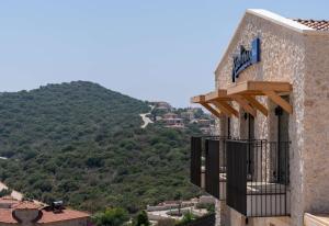 a building with a balcony with a view of a mountain at Radisson Blu Hotel, Kas in Kaş