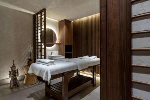 a bathroom with a white bed and a sink at Radisson Blu Hotel, Kas in Kaş