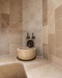 a bathroom with a bath tub with a sink at Radisson Blu Hotel, Kas in Kaş