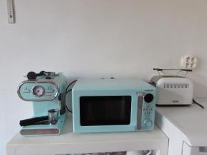 a microwave sitting on a table next to a toaster at Dům u rybníka in Nýdek