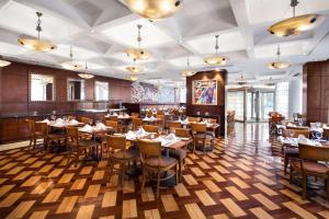 a restaurant with wooden floors and tables and chairs at Doubletree By Hilton Buenos Aires in Buenos Aires