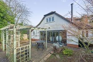 an extension to a house with a patio at Spacious 4 Bedroom House with Lovely Large Garden in Nottingham