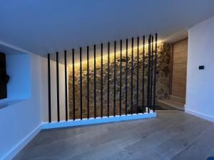 a room with a door with a wall of wine bottles at Casa Rural Hoyo del moro in Liétor +3 photos