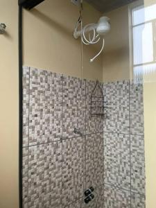 a shower with a glass door in a bathroom at Apto 2 otimo local proximo shopping in Campo Grande