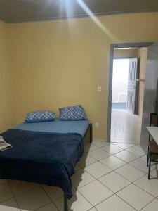 a bedroom with a bed and a door to a balcony at Apto 2 otimo local proximo shopping in Campo Grande