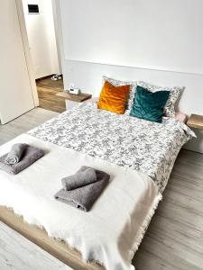 a bedroom with a large bed with pillows on it at New cozy apartment in Otopeni near airport in Otopeni