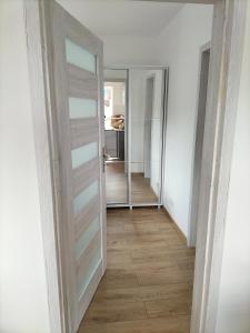 a hallway with a sliding door in a room at Dom nad morzem u Ewy Chłopy in Chłopy