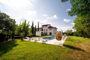 a villa with a swimming pool and a house at Villa Montefalcone: Charm, Private Pool, and Chef in Orentano