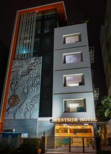 a building with a painting on the side of it at Westside Hotel Gachibowli in Hyderabad