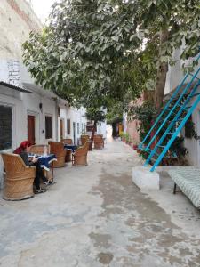 a person sitting at a table with a blue ladder at Hotel Old Moon Cafe in Pushkar +50 photos