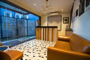 a living room with a couch and a large window at Hotel Bela Goa in Panaji