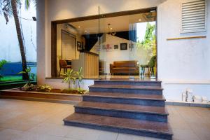 a lobby with stairs in front of a building at Hotel Bela Goa in Panaji