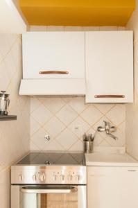 a kitchen with white cabinets and a stove at Bologna Easy Explore - AmbrogioHost in Bologna