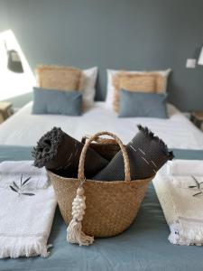 a basket sitting on top of a bed at Villa La Carpenée in Roquefort-les-Pins