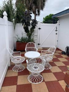 a patio with a table and chairs and a fence at Full Kitchen , Dream bathroom will be a memory:) in Kissimmee