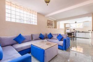 a living room with a blue couch and a table at House with Hot Tub Private - Close to Hivernage District in Marrakesh