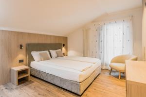 Postel nebo postele na pokoji v ubytování Suàn Hotel