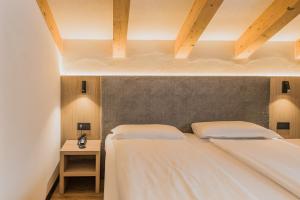 Postel nebo postele na pokoji v ubytování Suàn Hotel