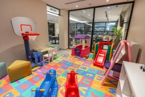 a childrens play area with toys on the floor at Marlo Hotel in Jeddah