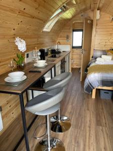 a kitchen and living room in a tiny house at The Sandy Pod in Stornoway