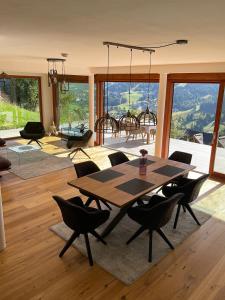 a living room with a wooden table and chairs at Mountain Fairy Tale in Bad Kleinkirchheim