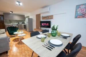 a dining table and chairs in a living room at Napa Centrale Suites in Ayia Napa