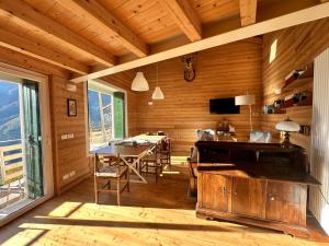 a wooden room with a table and a dining room at CIELO E TERRA Chalet a Zencheri in Piazza