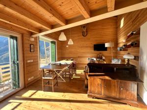 a wooden room with a table and a dining room at CIELO E TERRA Chalet Zencheri con vista panoramica in Piazza +83 photos