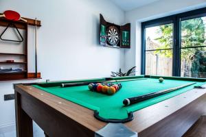 a pool table with balls on it in a room at Balmoral House in Timperley