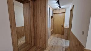 a hallway of a house with wood paneling at Vuk Vučko in Jahorina