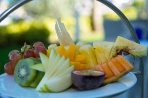 a plate of fruit and vegetables on a table at Royal Blues Hotel in Deerfield Beach
