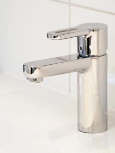 a bathroom sink with a silver faucet at Santo's Higham Farm Hotel in Alfreton