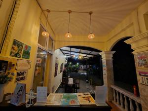 a restaurant with a table in the middle of a hallway at Saphaothong guesthouse in Vang Vieng