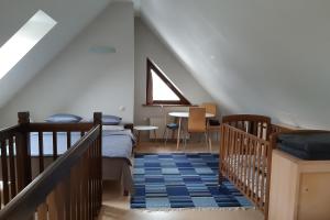 a bedroom with a bed and a staircase with a window at Lazdas in Saulkrasti