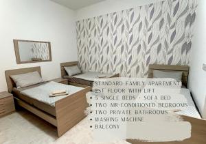 a bedroom with two beds and a wall mural at Arzella - spacious two bedroom apartments in Xlendi