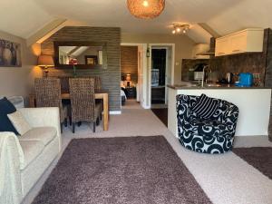 ein Wohnzimmer und eine Küche mit einem Sofa und einem Tisch in der Unterkunft Beaconsfield Farm in Wells
