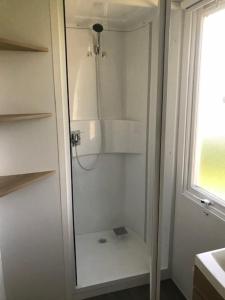 een douche met een glazen deur in de badkamer bij KERLANN 4 ETOILES MOBIL HOME 2CHS 1SDB Pont Aven Finistère in Pont-Aven
