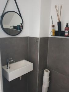 a bathroom with a white sink and a mirror at @Salland in Zwolle