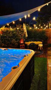 a hot tub in a backyard at night at Studio cocooning in Vauvert