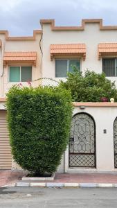 a large green bush in front of a building at Chic 3-BR Tala Almajd Villas in upscale district Alnahdah Family only in Jeddah