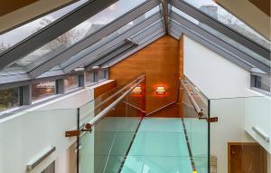 a glass staircase in a house with a glass floor at 2 Bedroom Awesome Home In lesund in Ålesund