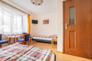 Postel nebo postele na pokoji v ubytování Dom Gościnny Ewa