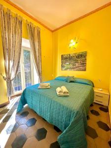 スビアーコにあるGuest House Subiaco LA DOMUSの黄色のベッドルーム(ベッド1台、タオル2枚付)