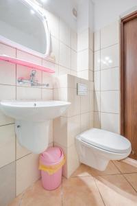a bathroom with a sink and a toilet at Dom Gościnny Ewa in Rewal