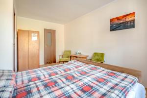 a bedroom with a bed and a table and chairs at Dom Gościnny Ewa in Rewal