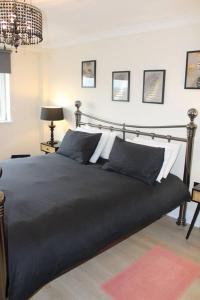 a bedroom with a large black bed in a room at Urban Oasis: North London in Edmonton